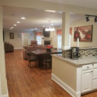 A modern open-concept kitchen and dining area with hardwood floors.