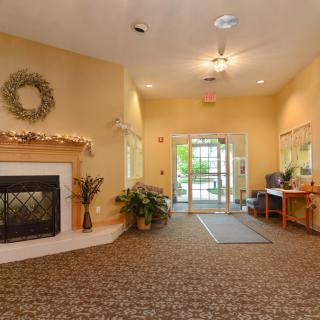 A cozy lobby with a fireplace and welcoming entrance.