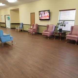 A spacious lobby featuring comfortable seating options and a television.