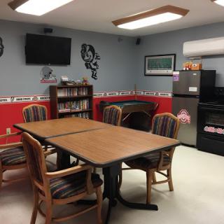 A cozy meeting room equipped with a table, chairs, and various amenities for collaborative activities.