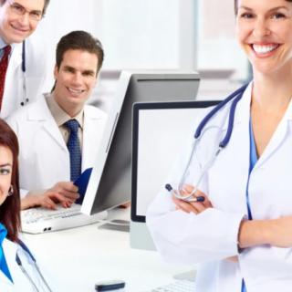 A group of smiling doctors in a medical office environment.