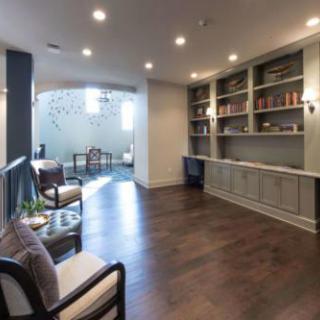 A modern living room with built-in bookshelves and a comfortable seating area.