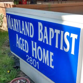 Sign for the Maryland Baptist Aged Home, indicating a facility dedicated to elder care.