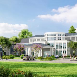 A modern luxury residential building surrounded by lush greenery and a clear blue sky.