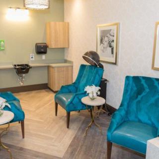 A stylish waiting room featuring modern lounge chairs and elegant decor.