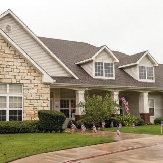 A suburban house with a stone and siding exterior.