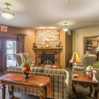 A cozy living room with a fireplace and comfortable seating.