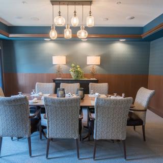 A modern dining room with elegant lighting and furniture.