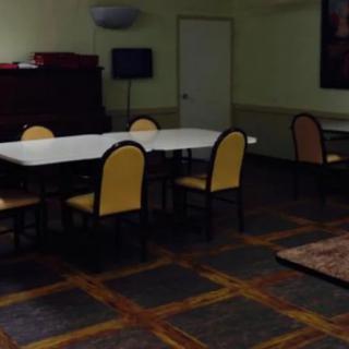 An empty dining area with tables and chairs.