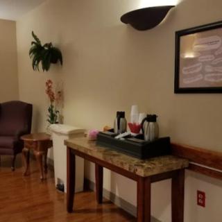 A cozy waiting area with a coffee station and seating.