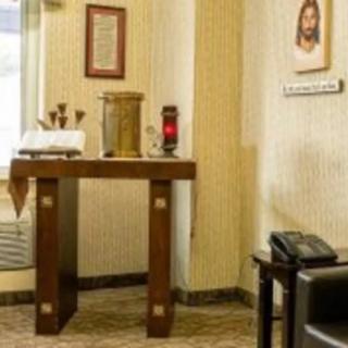 A small chapel area with an altar and religious symbols.