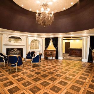Luxurious interior with elegant seating, chandelier, and a beautiful wooden floor.