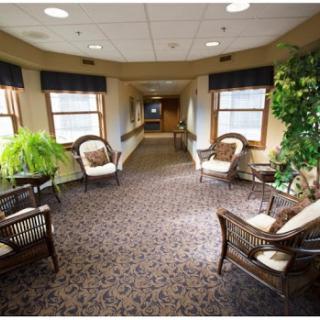 A warm and inviting hallway with comfortable seating and natural light.