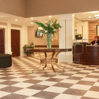 A welcoming hotel lobby with a checkered floor and elegant decor.