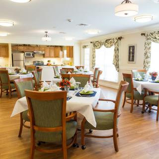 A well-decorated dining area with multiple tables and chairs arranged neatly.