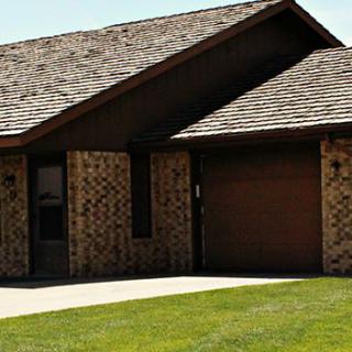 A single-story brick house with a garage.