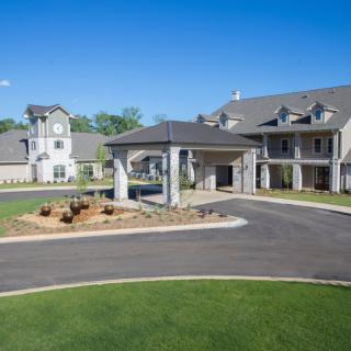 A luxurious residential estate with a grand entrance and well-maintained landscaping.