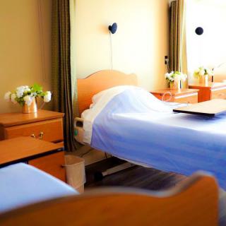A clean and organized hospital room with neatly arranged beds.