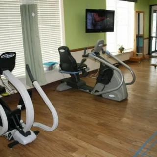A modern gym featuring various exercise equipment for cardio workouts.