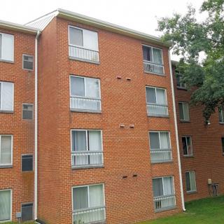 A brick apartment building with multiple floors and windows.
