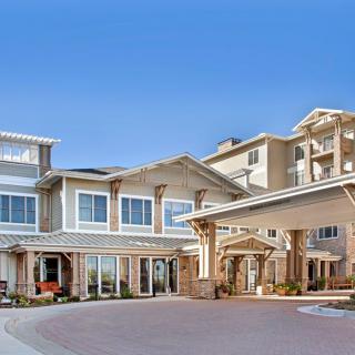 A modern residential building with a welcoming entrance and multiple stories.