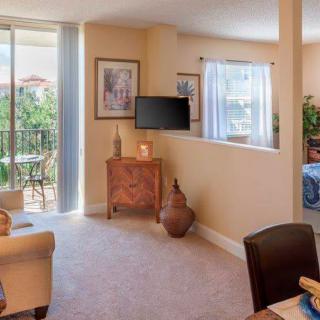 A cozy apartment living room with a view of the balcony.