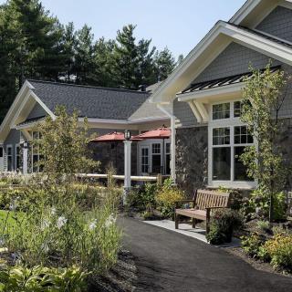 A charming residential building with well-maintained landscaping and a garden path.