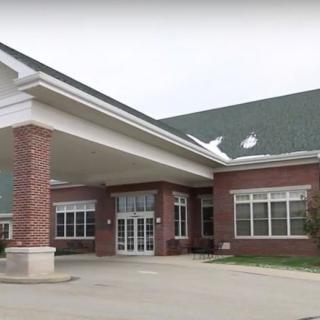 A building with a prominent entrance and brick exterior.