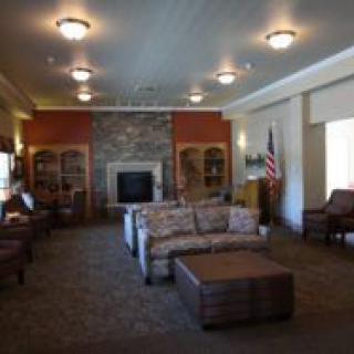 A cozy living room interior with a fireplace and comfortable seating.