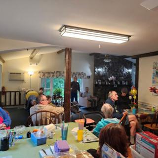A group of people gathering in a cozy living room for a social event.