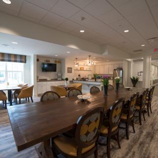 A spacious dining area with a modern kitchen and elegant furnishings.