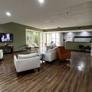 A modern lounge area featuring comfortable seating and a welcoming atmosphere, perfect for relaxation or waiting.