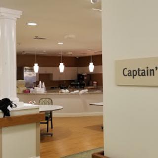 A view of a dining area with a prominent sign labeled 'Captain'.