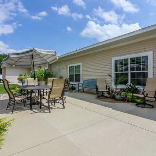 A spacious patio with outdoor furniture under a bright blue sky.