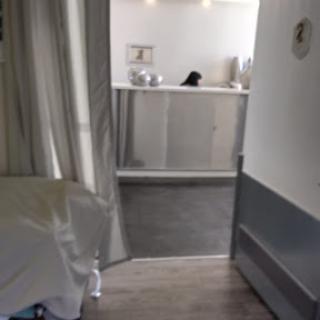 A view of a medical room leading to a reception area.
