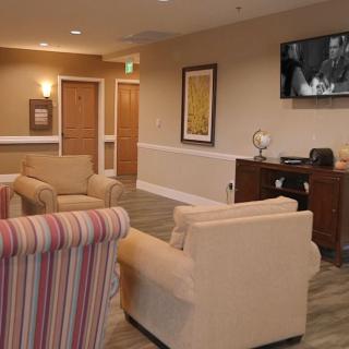A cozy lobby area with comfortable seating and a television.