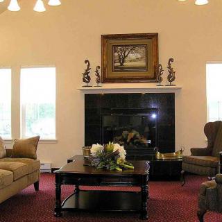 A cozy living room with a fireplace, sofas, and a coffee table.