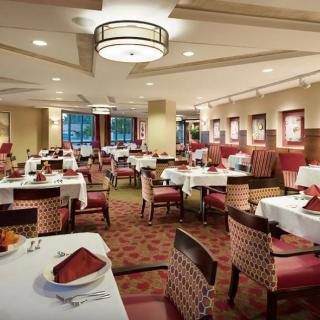 An elegantly decorated restaurant dining room with neatly arranged tables and chairs.