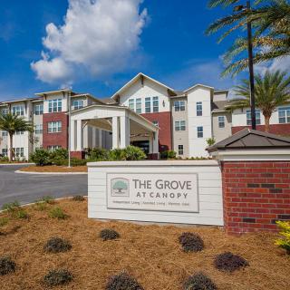 A residential building with a sign reading 'The Grove St. Andrews' surrounded by landscaped grounds.