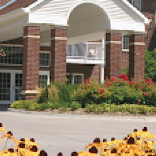 A charming residential building with vibrant flowers in the foreground.