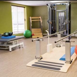 A well-equipped gym space designed for fitness and rehabilitation exercises.