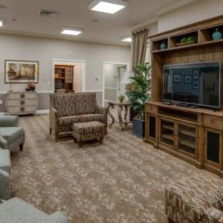 A cozy living room with comfortable seating and a large entertainment center.