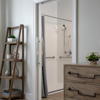A modern bathroom with a sleek shower and minimalist decor.