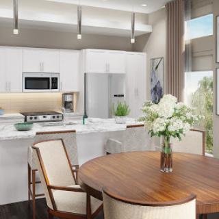 A beautifully designed modern kitchen featuring sleek white cabinetry and a cozy dining area with floral accents.