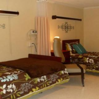 A cozy bedroom with two beds featuring floral bedding and stylish decor.