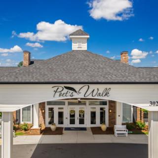 Front entrance of the Pete's Wok restaurant under a blue sky with clouds.