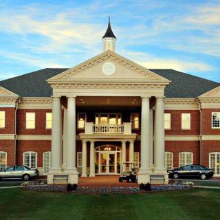 A grand building with a symmetrical design and prominent columns at the entrance.