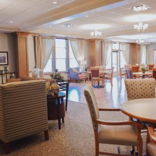 A well-lit lounge area with comfortable seating and large windows.