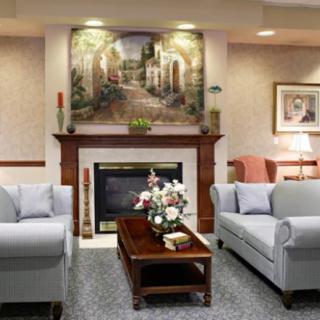 A cozy living room with sofas, a fireplace, and elegant decor.