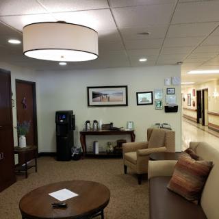 A cozy waiting area featuring comfortable seating and warm lighting.